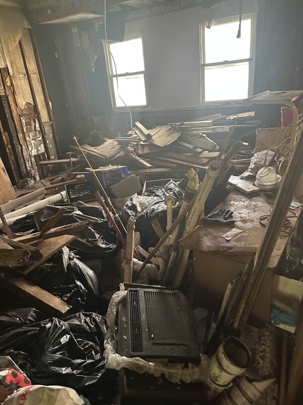 Room packed with junk and debris before cleanout